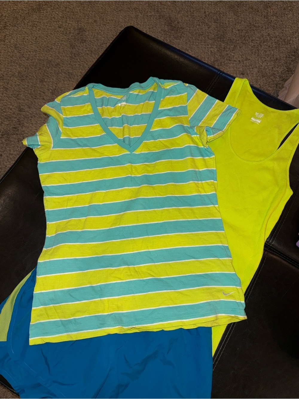 Women's Nike tops and shorts. The tops and shorts have complementing colors.